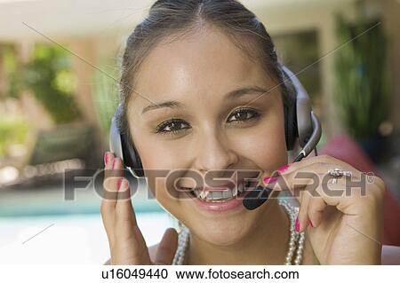 Young woman by swimming pool with headset, close up, portrait View Large Photo Image Stock Image - Young woman by swimming pool with headset, close up, portrait. Fotosearch