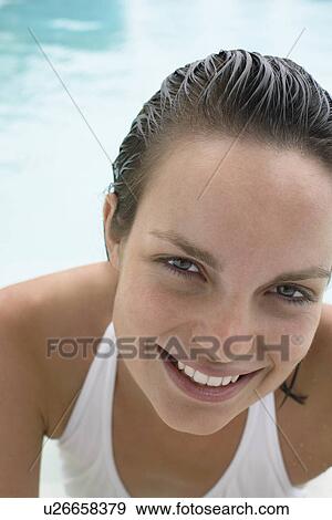 Young woman in swimming pool, portrait, close-up View Large Photo Image Stock Photo - Young woman in swimming pool, portrait, close-up. Fotosearch