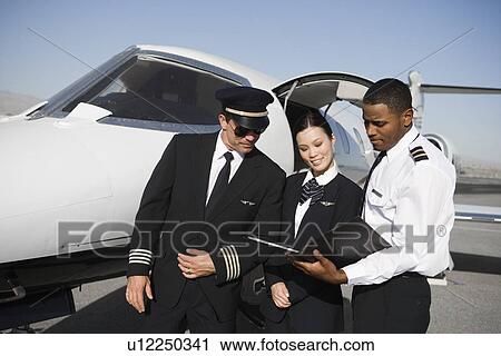 Stock Image - Aeroplane crew on runway.. Fotosearch