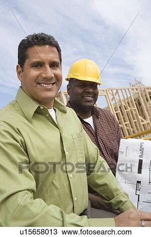 Architect and construction worker on construction site View Large Photo Image Stock Image - Architect and construction worker on construction site. Fotosearch