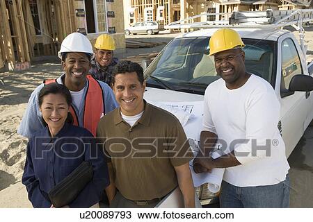 Architect and four construction workers standing in front of car on construction site View Large Photo Image Stock Image - Architect and four construction workers standing in front of car on construction site. Fotosearch