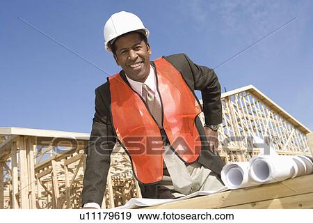 Architect leaning to table with blueprints View Large Photo Image Stock Photo - Architect leaning to table with blueprints. Fotosearch