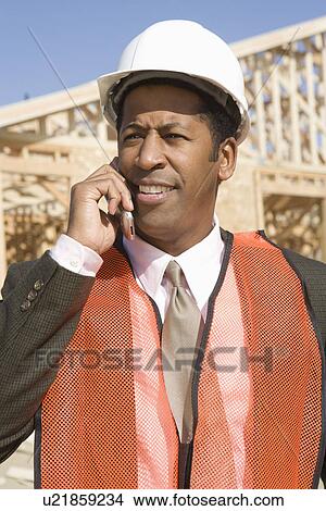 Picture - Architect talking on mobile phone. Fotosearch