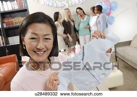 Stock Image - Asian woman at a Baby Shower. Fotosearch