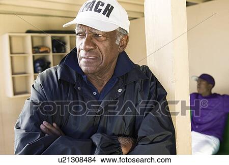 Picture - Baseball coach in dugout. Fotosearch
