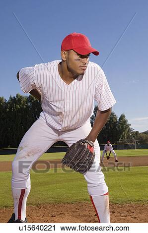 Baseball pitcher preparing to throw during game View Large Photo Image Stock Image - Baseball pitcher preparing to throw during game. Fotosearch