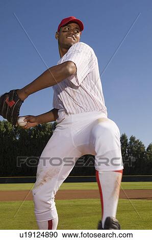 Baseball pitcher throwing ball during game View Large Photo Image Stock Image - Baseball pitcher throwing ball during game. Fotosearch