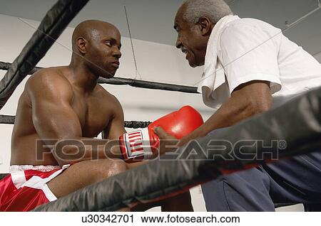 Stock Image - Boxer and Coach in Ring. Fotosearch
