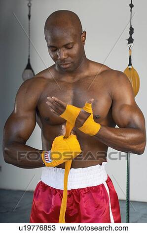 Stock Image - Boxer Taping Hands Before Fight. Fotosearch