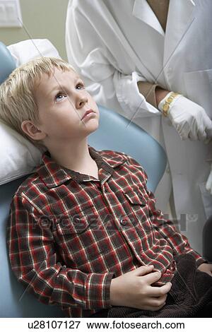 Stock Photo - Boy (6-9) at dentists. Fotosearch