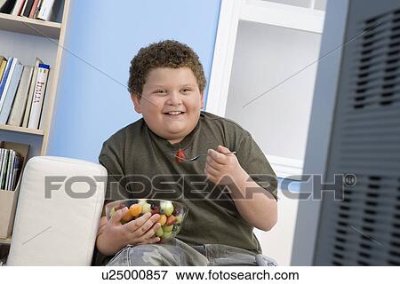 Stock Photo - Boy Eating Bowl of Fruit. Fotosearch