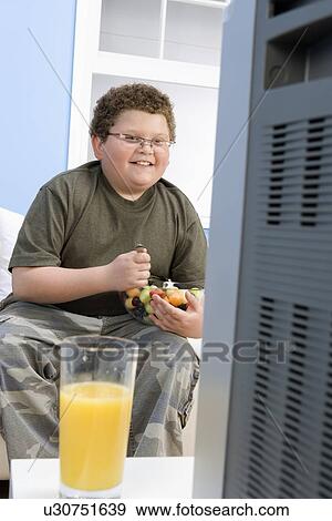 Stock Photo - Boy Eating Bowl of Fruit. Fotosearch