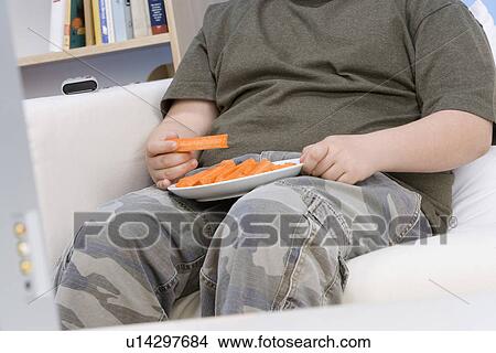 Picture - Boy Eating Carrot Sticks. Fotosearch