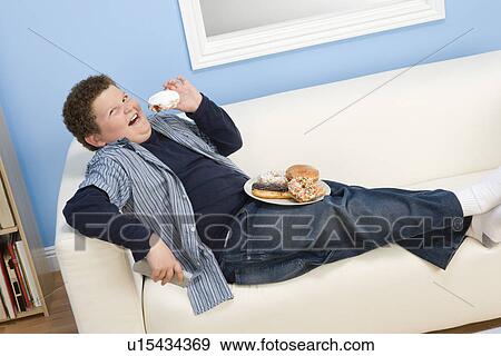 Boy Eating Donuts View Large Photo Image Stock Photo - Boy Eating Donuts. Fotosearch