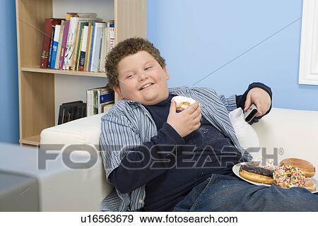 Boy Eating Donuts View Large Photo Image Stock Photo - Boy Eating Donuts. Fotosearch