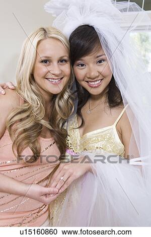 Stock Image - Bride and bridesmaid at bridal shower. Fotosearch