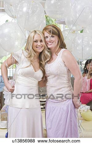 Bride and Friend standing Together holding balloons at Bridal Shower View Large Photo Image Stock Photo - Bride and Friend standing Together holding balloons at Bridal Shower. Fotosearch
