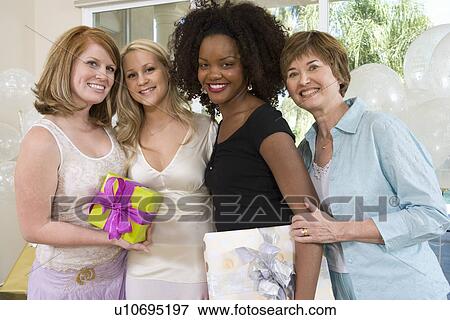 Bride and Friends standing Together holding gifts at Bridal Shower View Large Photo Image Stock Photo - Bride and Friends standing Together holding gifts at Bridal Shower. Fotosearch
