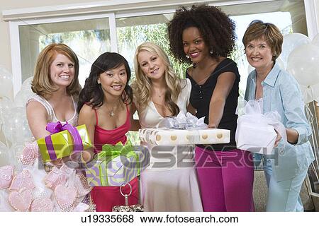Bride and Friends standing Together holding gifts at Bridal Shower View Large Photo Image Stock Photo - Bride and Friends standing Together holding gifts at Bridal Shower. Fotosearch