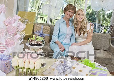Stock Photograph - Bride and her Friend sitting Together at Bridal Shower. Fotosearch