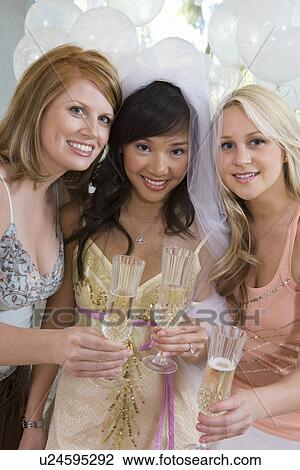 Stock Image - Bride celebrating at bridal shower with friends. Fotosearch