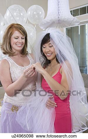 Bride showing friend her engagement ring at Bridal Shower View Large Photo Image Stock Photo - Bride showing friend her engagement ring at Bridal Shower. Fotosearch