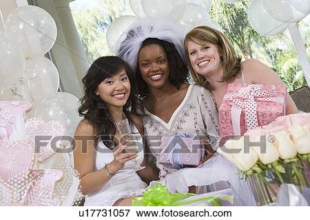 Bride with friends celebrating bridal shower View Large Photo Image Stock Photo - Bride with friends celebrating bridal shower. Fotosearch