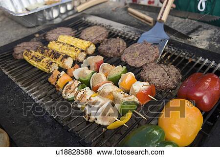 Stock Photo - Burgers and Kebabs on Barbecue Grill. Fotosearch