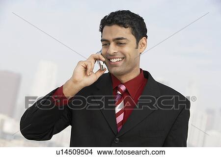 Business man using mobile phone outdoors View Large Photo Image Picture - Business man using mobile phone outdoors. Fotosearch