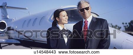 Businessman and Flight Crew Standing by Airplane View Large Photo Image Stock Image - Businessman and Flight Crew Standing by Airplane. Fotosearch
