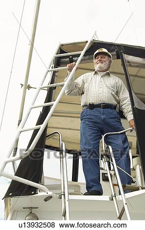 Stock Photo - Captain on boat. Fotosearch