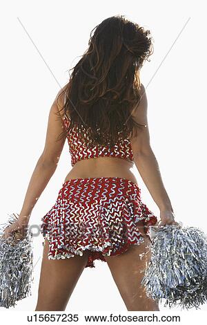 Stock Photography - Cheerleader with pom poms, back view. Fotosearch