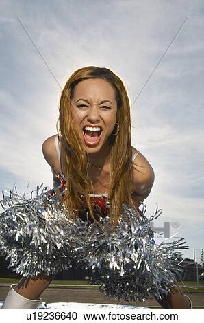 Cheerleader with poms poms View Large Photo Image Stock Image - Cheerleader with poms poms. Fotosearch