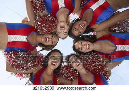 Stock Photo - Cheerleaders in a Huddle from below. Fotosearch
