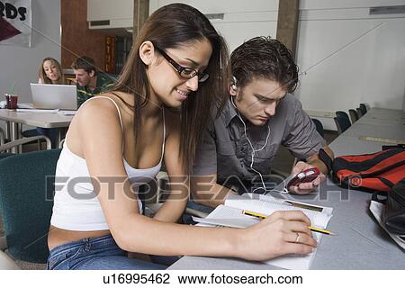 Stock Image - College students studying together in classroom. Fotosearch