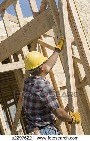 Construction worker at work on building View Large Photo Image Stock Image - Construction worker at work on building. Fotosearch