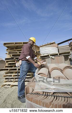 Construction worker at work on site View Large Photo Image Stock Image - Construction worker at work on site. Fotosearch