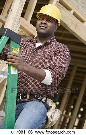 Construction worker climbing ladder View Large Photo Image Stock Photograph - Construction worker climbing ladder. Fotosearch