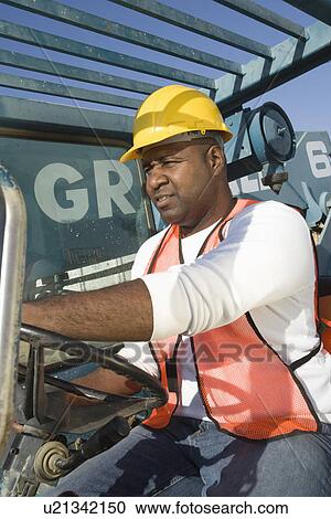 Construction worker driving vehicle View Large Photo Image Stock Image - Construction worker driving vehicle. Fotosearch