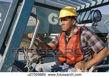 Stock Photography - Construction worker driving vehicle. Fotosearch