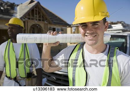 Construction worker holding blueprint, portrait View Large Photo Image Stock Image - Construction worker holding blueprint, portrait. Fotosearch