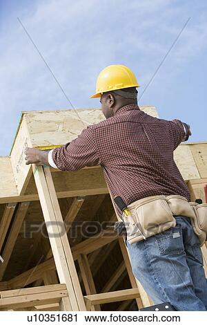 Stock Image - Construction worker on building. Fotosearch