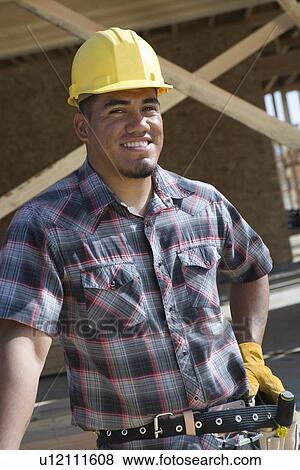Stock Photo - Construction worker standing on construction site. Fotosearch