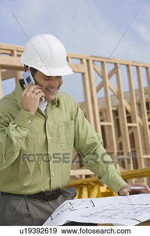 Construction worker studying blueprint View Large Photo Image Stock Photo - Construction worker studying blueprint. Fotosearch