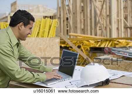Construction worker using laptop View Large Photo Image Stock Image - Construction worker using laptop. Fotosearch