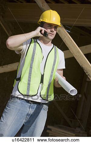 Construction worker using mobile phone View Large Photo Image Stock Image - Construction worker using mobile phone. Fotosearch