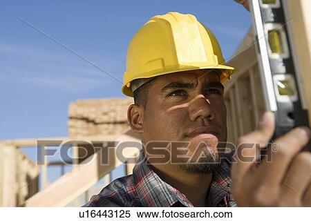 Stock Photography - Construction worker using spirit level. Fotosearch
