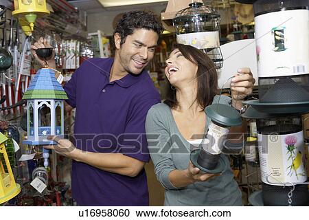 Stock Image - Couple choosing lanterns in shop. Fotosearch