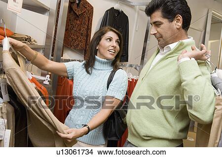 Picture - Couple clothes shopping together. Fotosearch