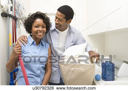 Stock Photo - Couple doing housework. Fotosearch